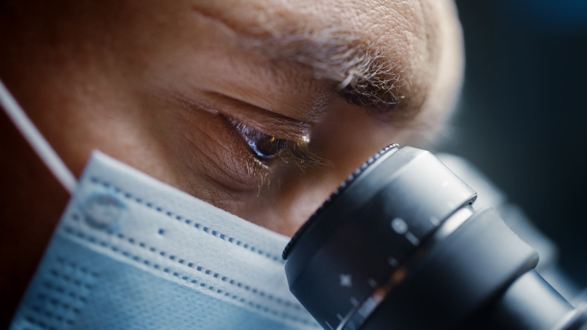 Life science researcher at a microscope